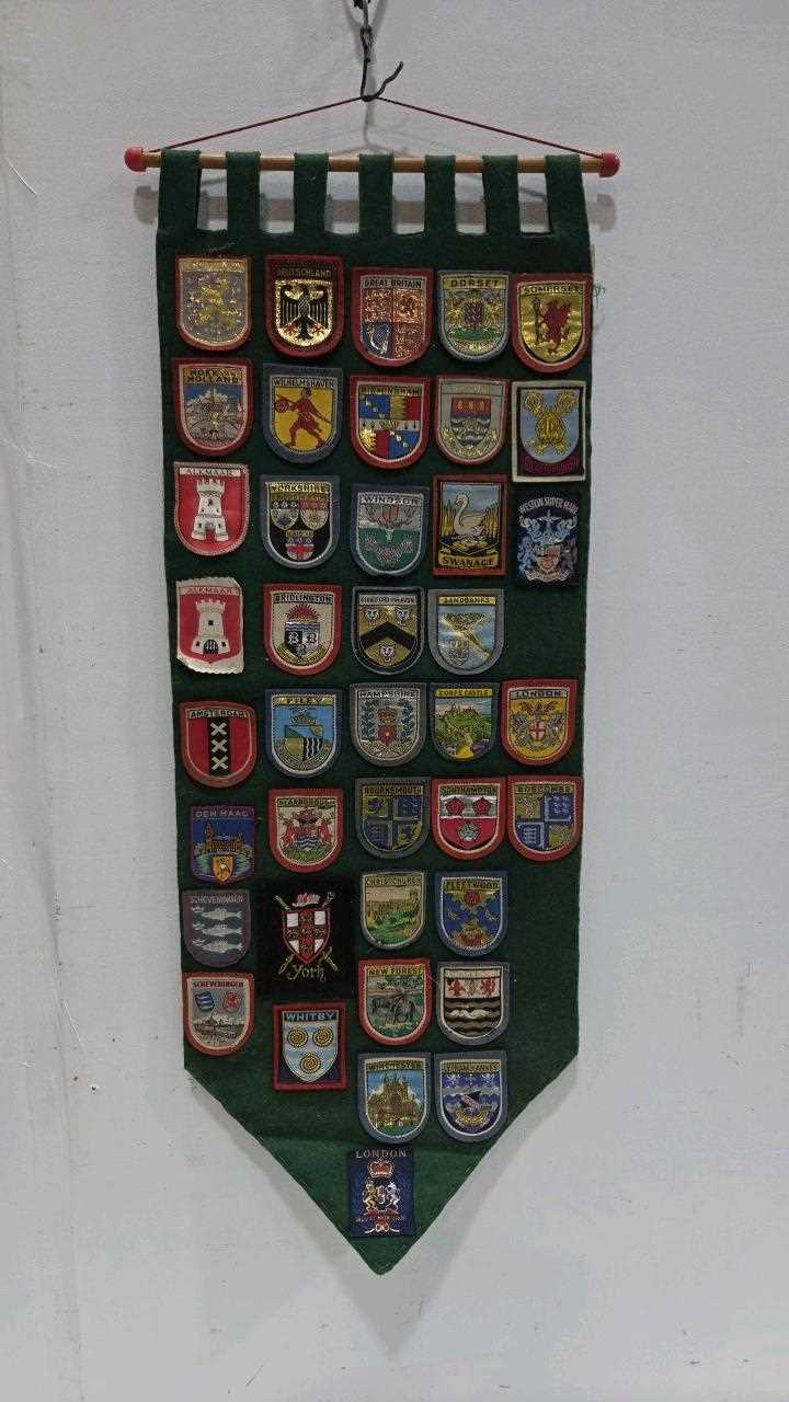 Lot 875 - BANNER WITH UK,DUTCH & GERMAN TRAVEL BADGES FROM THE 1950'S