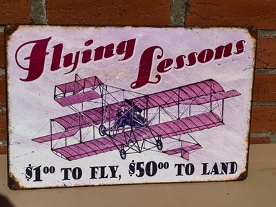 Lot 549 - FLYING LESSONS TIN REPRO SIGN 17.5" X 11.5"