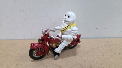 Lot 115 - CAST MICHELIN MAN ON A MOTOR CYCLE 7" X 9"
